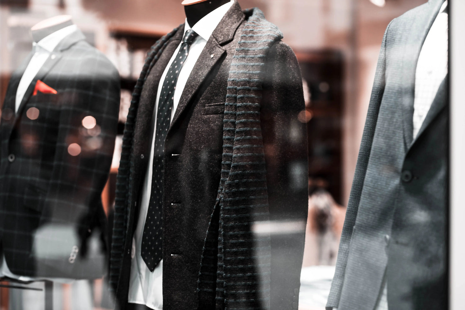 Mannequin wearing a formal suit with a tie in a store setting